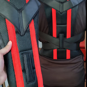 Black and red back support brace worn by a person