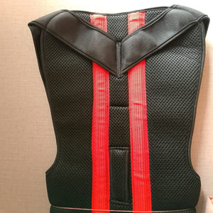 Black protective vest with red straps on a beige background